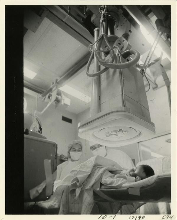 Doctor and nurse running a test on infant patient