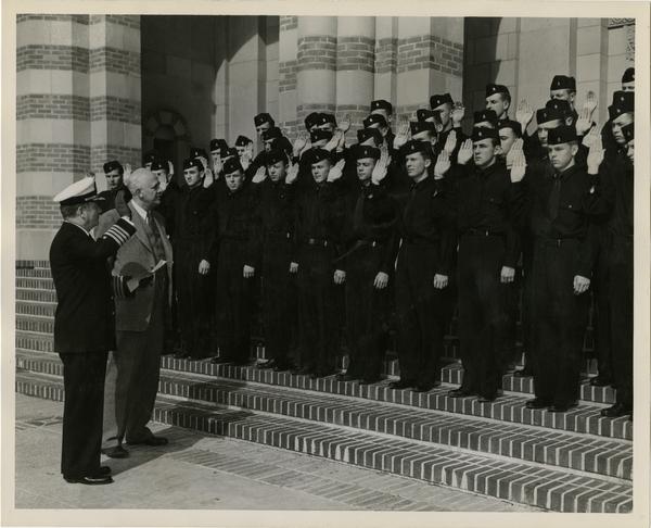Captain William C. Barker and Provost Clarence A. Dykstra with Navy ROTC cadets in front of Royce Hall