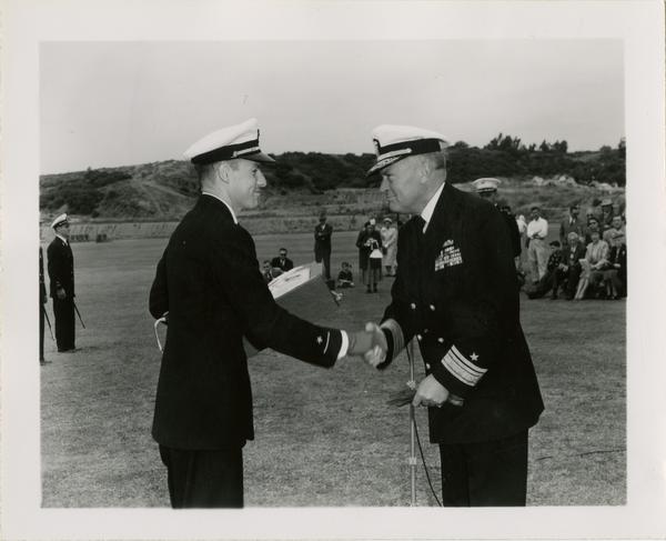 Captain L.C. Grannis congratulating naval ensign