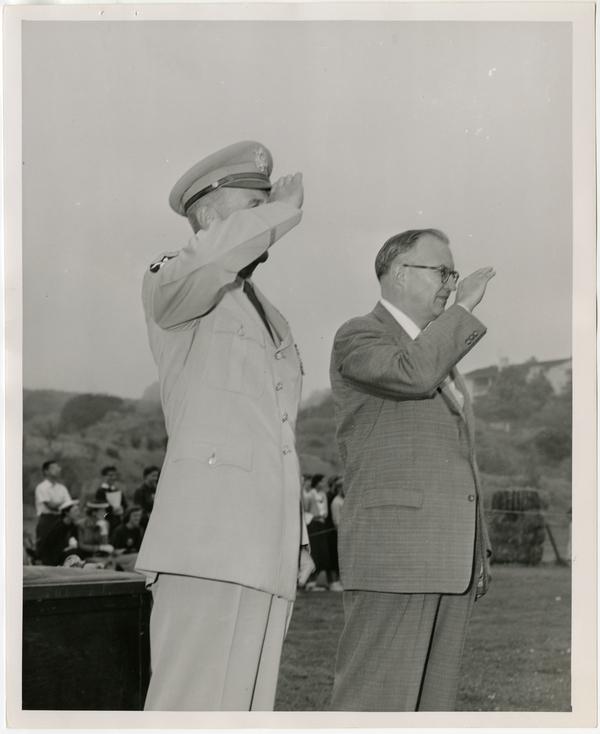 Photo of Chancellor Raymond B. Allen and officer saluting, ca. 1956