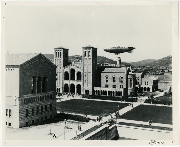 View of Powell Library and Royce Hall as Good Year Blimp flies by