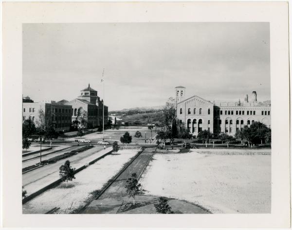 View of Dickson Court after snowfall with Humanities Hall, Powell Library, and Haines Hall in background, ca January 1949