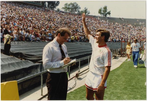 UCLA team member, Paul Caligiuri, waving to crowd at 1986 FIFA World Cup All-Star Game, July 1986