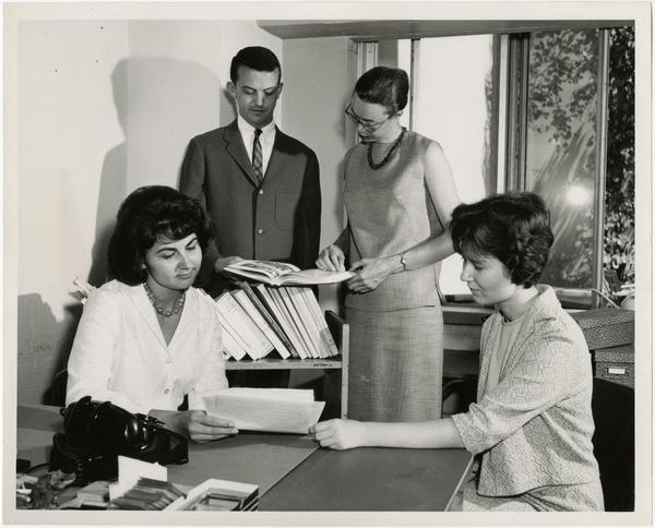 Professionals gathered in office in the School of Social Welfare