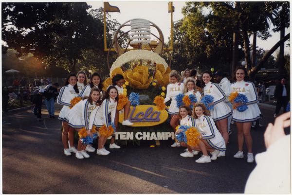 Spirit Squad posing in front of UCLA champion float