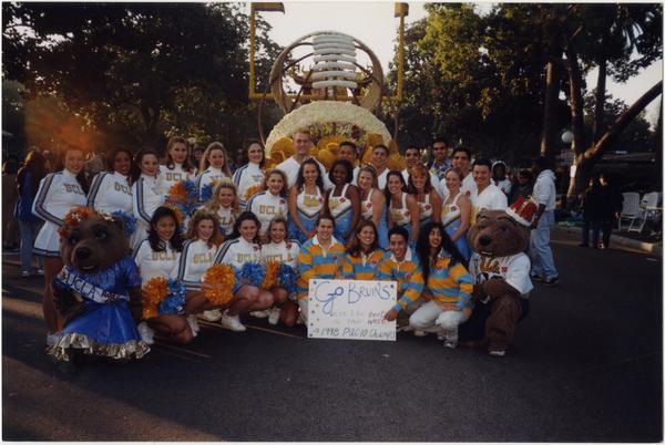 Spirit Squad posing in front of UCLA PAC-10 Champion float, 1998