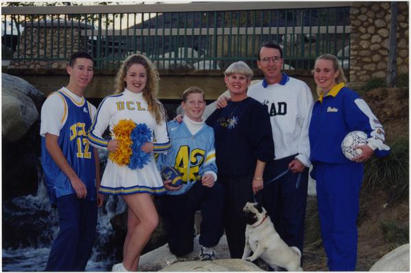 Spirit Squad member with group of people in UCLA regalia