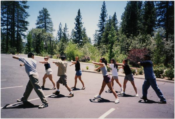 Spirit Squad stretching in parking lot, ca. July 1998