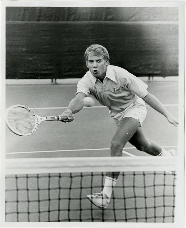 NCAA champion, Billy Martin, hitting ball with raquet