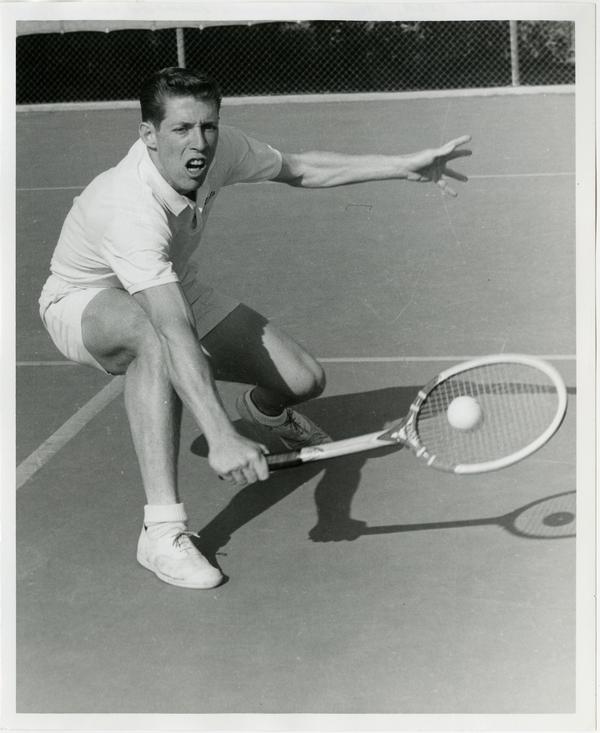 NCAA champion, Larry Nagler, hitting ball with raquet, ca. 1960s