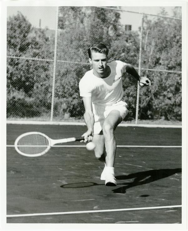 NCAA champion, Bob Perry, hitting ball with raquet, ca. 1950s