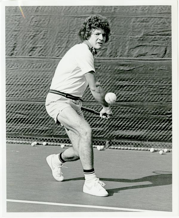 NCAA champion, Ferdi Taygan, hitting ball with raquet, ca. 1970s