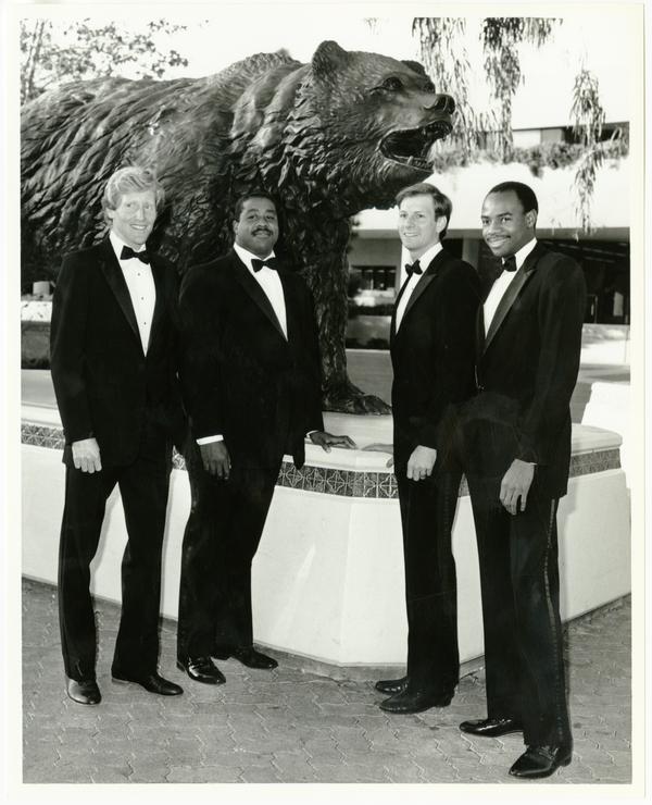 UCLA Track seniors in front of bear statue