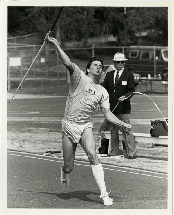 UCLA track team member throwing javelin