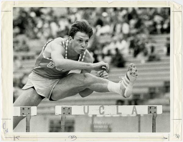 Steve Kerho jumping over hurdle