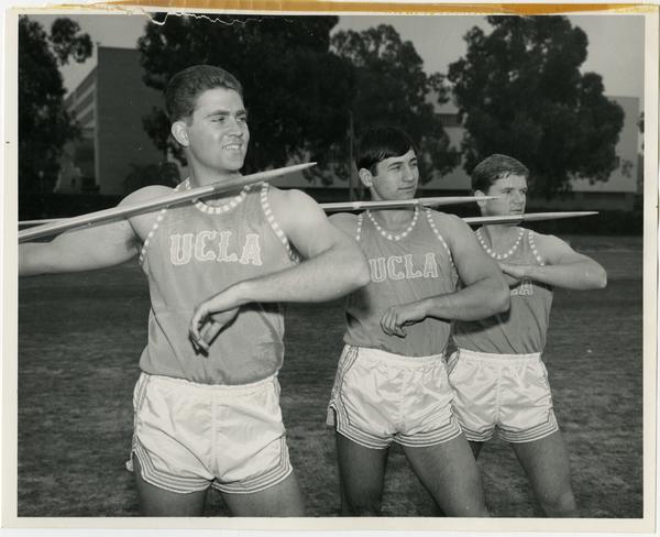 Track team members posing with javelins