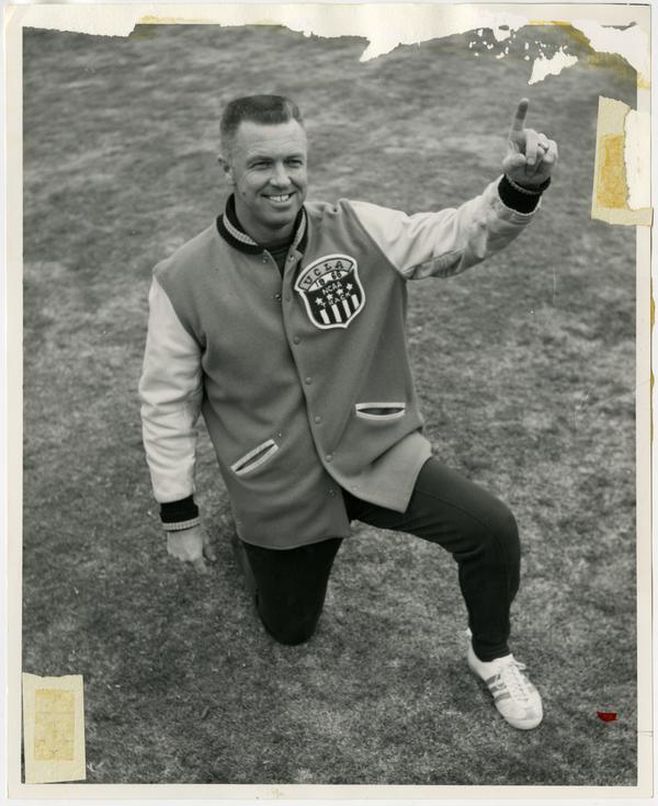 Track team coach Jim Bush wearing NCAA jacket, ca. 1966