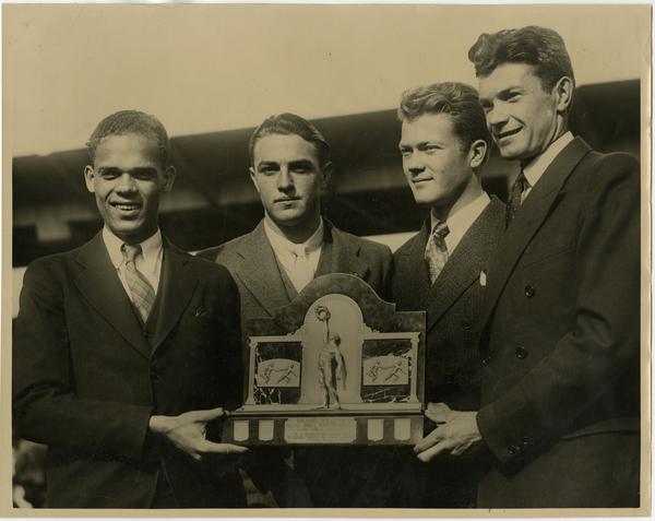 One mile University class champions James Lu Valle, Ray Vejar, Sinclair Lott, and James Miller in De Moines, Iowa at Drake Relays, ca. 1934