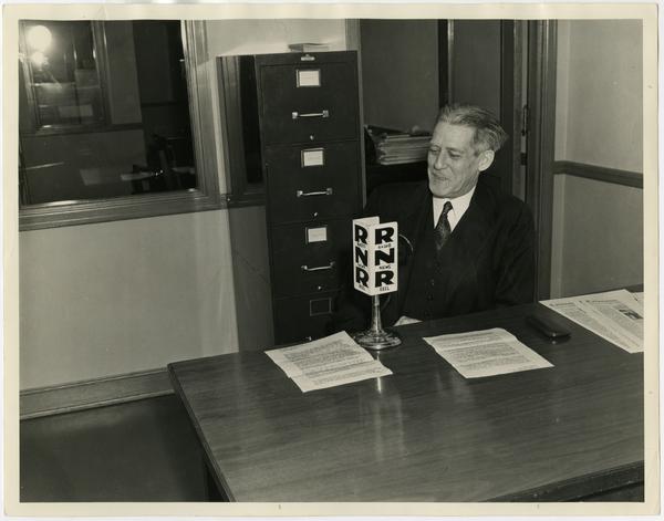 Provost Earle Hedrick sitting at desk