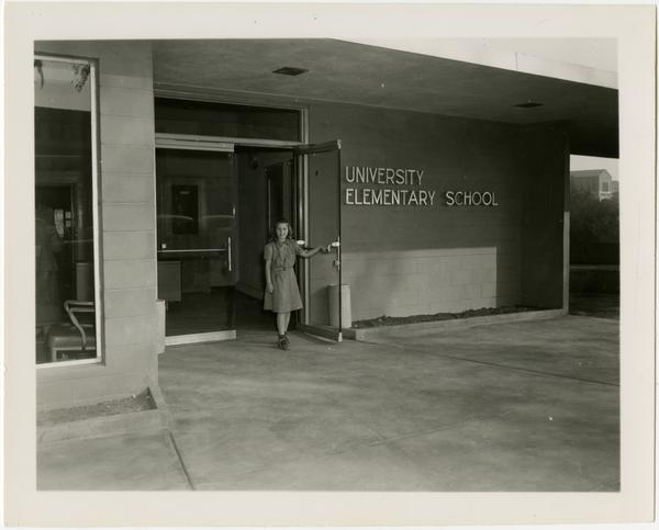 Student standing at entrance of University Elementary School