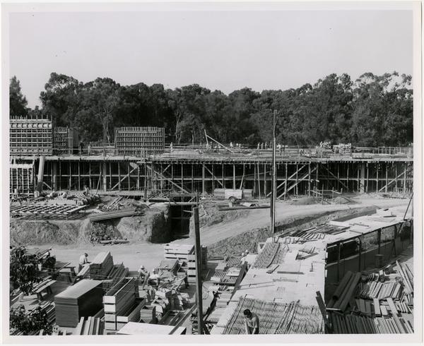 View of partial construction of the University Research Library with workers in the foreground