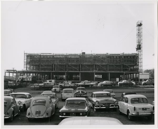Side view of the construction of the University Research Library from parking lot