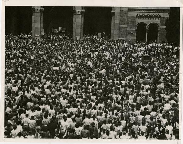 Student protesters crowded on Royce Hall quad with musicians in center, ca. 1967