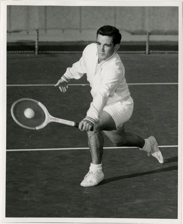 UCLA tennis team member, Ian Crookenden, hitting ball with raquet, ca. 1965