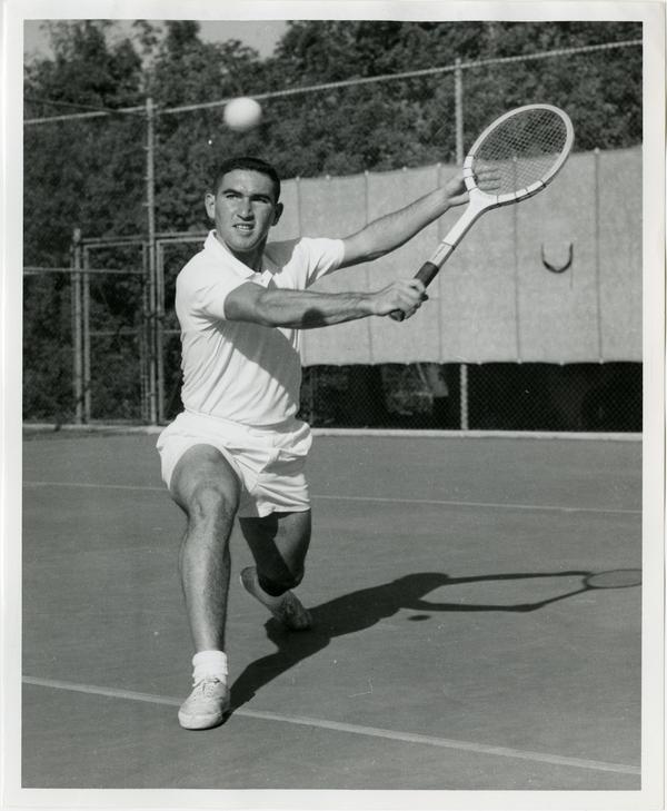 NCAA champion, Allen Fox, hitting ball with raquet, ca. 1960s