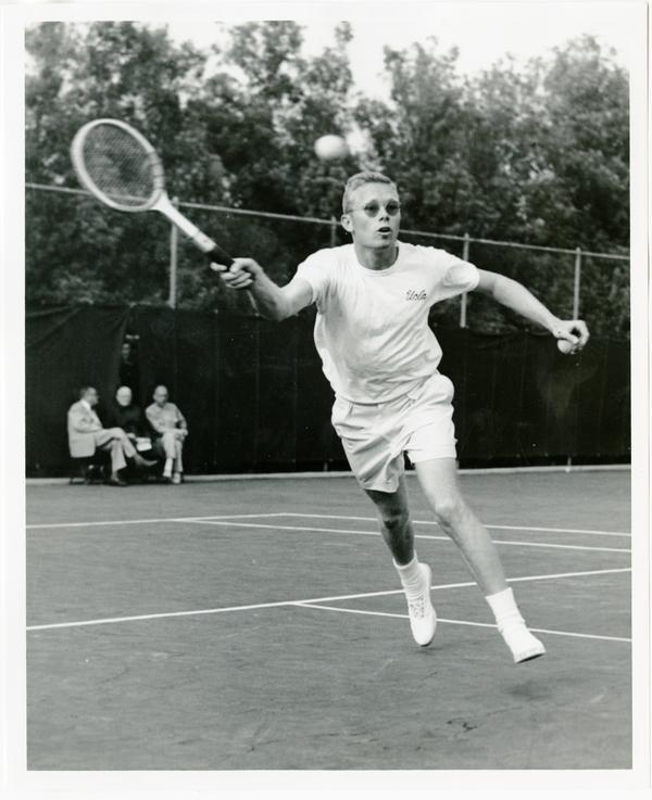 NCAA champion, Larry Huebner, hitting ball with raquet, ca. 1950s