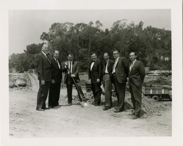 William G. Young, Robert Vosper, and others posing on the site of the new University Research Library during the groundbreaking ceremony, April 26, 1926