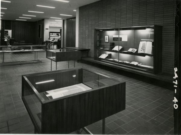 Display of libarry materials in glass cases in the University Research Library, ca. 1964