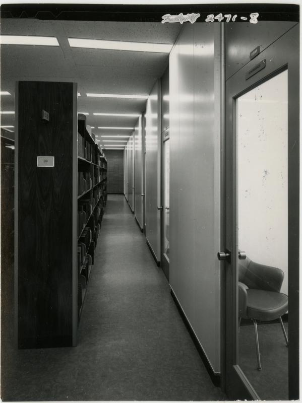 Looking down a corridor of the University Research Library next to the stacks, ca. 1964