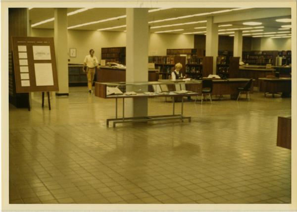 View of stacks and reference desk in University Research Library, ca. 1964