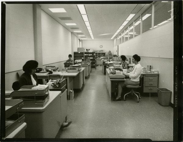 Contact print of University Research Library staff working at their desks