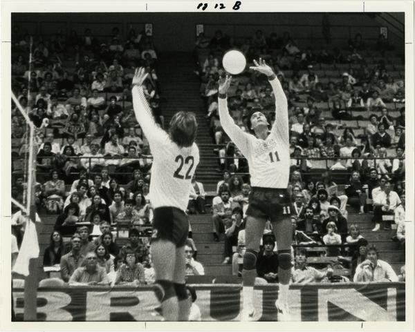 UCLA volleyball players setting up a shot during a game
