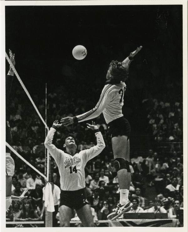 UCLA volleyball team player about to spike the ball during a game