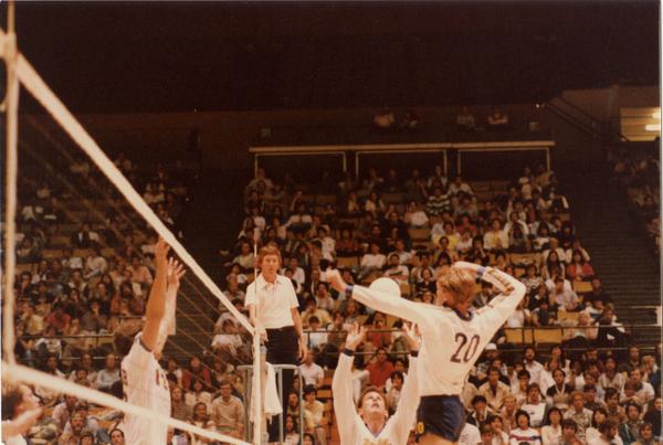 Two UCLA volleyball players setting upa shot during a game, 1983