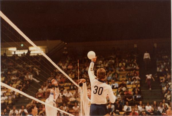 UCLA volleyball player hitting the ball during a game, 1983