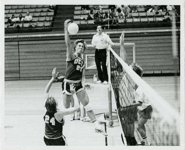 UCLA volleyball player about to spike the ball during a game, 1983