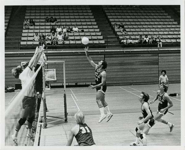 UCLA volleyball player reaching for ball during a game