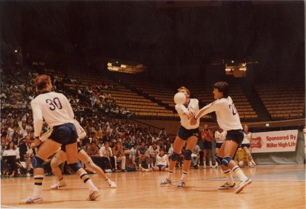 UCLA volleyball players hitting the ball during a game, 1983