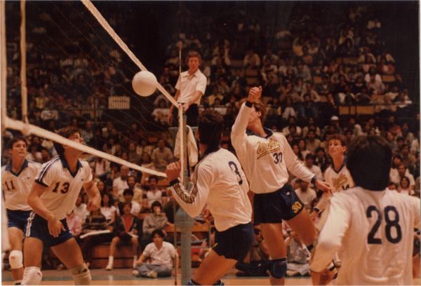 UCLA volleyball player after hitting the ball during a game, 1983