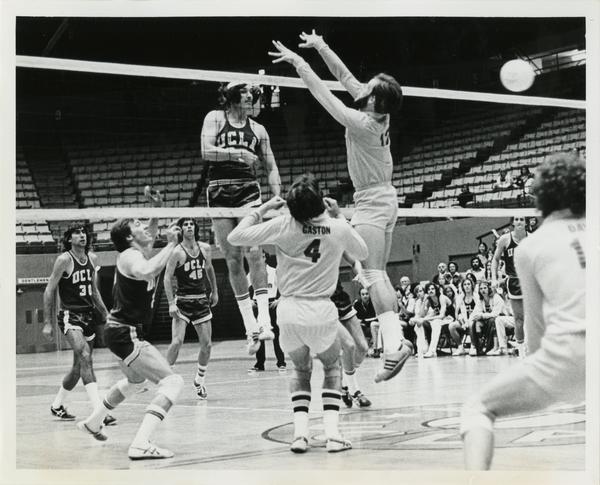UCLA volleyball player, David Olbright setting the ball for hitter, Mike Gottschal