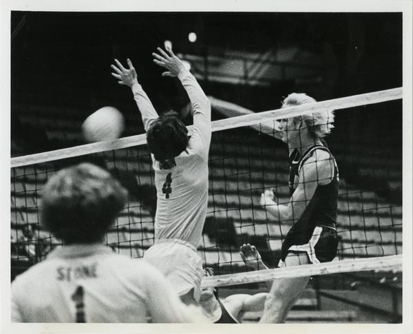 UCLA Volleyball player, Doug Rabe, drives the spike inside the CSULB block.
