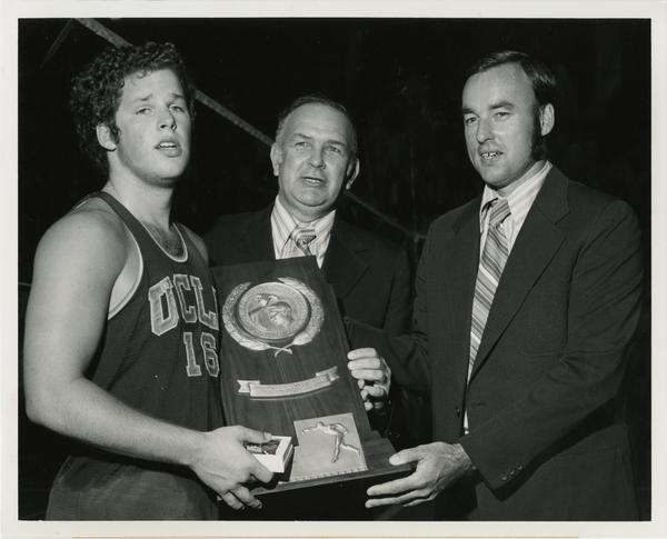UCLA Volleyball player, Dick Irvine, holding 1972 NCAA championship award with Walter Versen and Al Scates