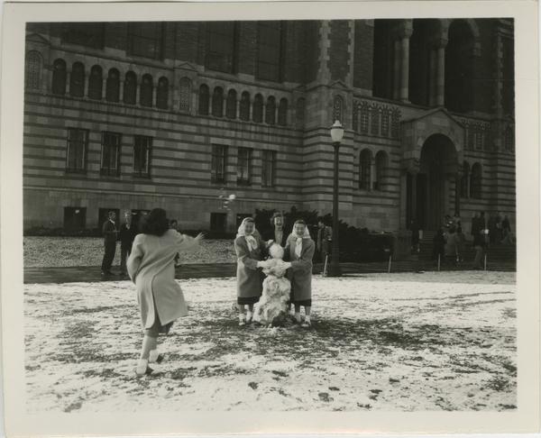 Campus Snow Scene with Female Students and Snowman in Front of Powell Library, 1932 Jan. 15