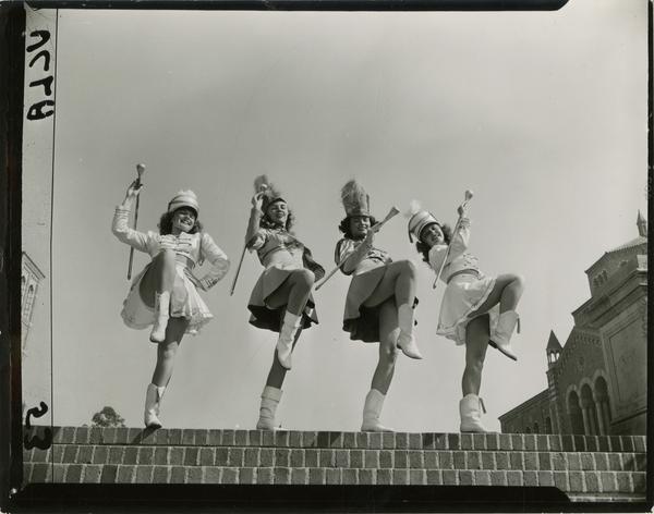 Contact print of four majorettes posing with batons at the top of the Janss Steps, ca. 1940's