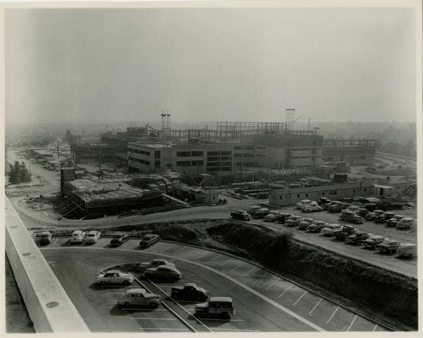 UCLA medical center after more construction has occurred with the surrounding parking lot with cars in it, c. 1951