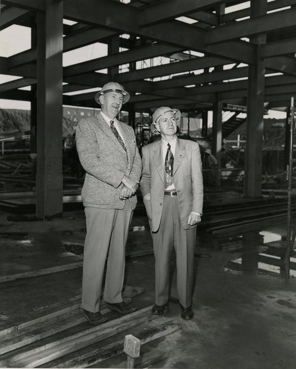 Two members of the construction inspection team pose for a photo at the construction site of the UCLA medical center, c. 1951